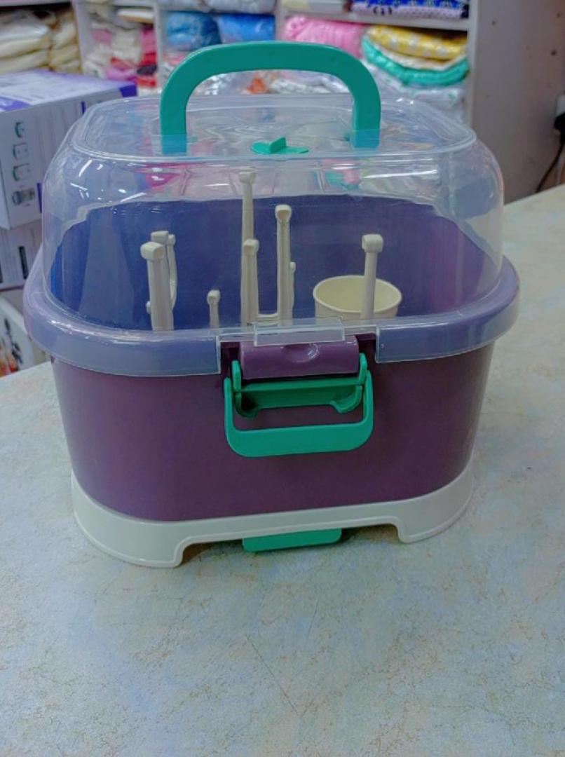 Classic Baby bottle drying rack with a lid.