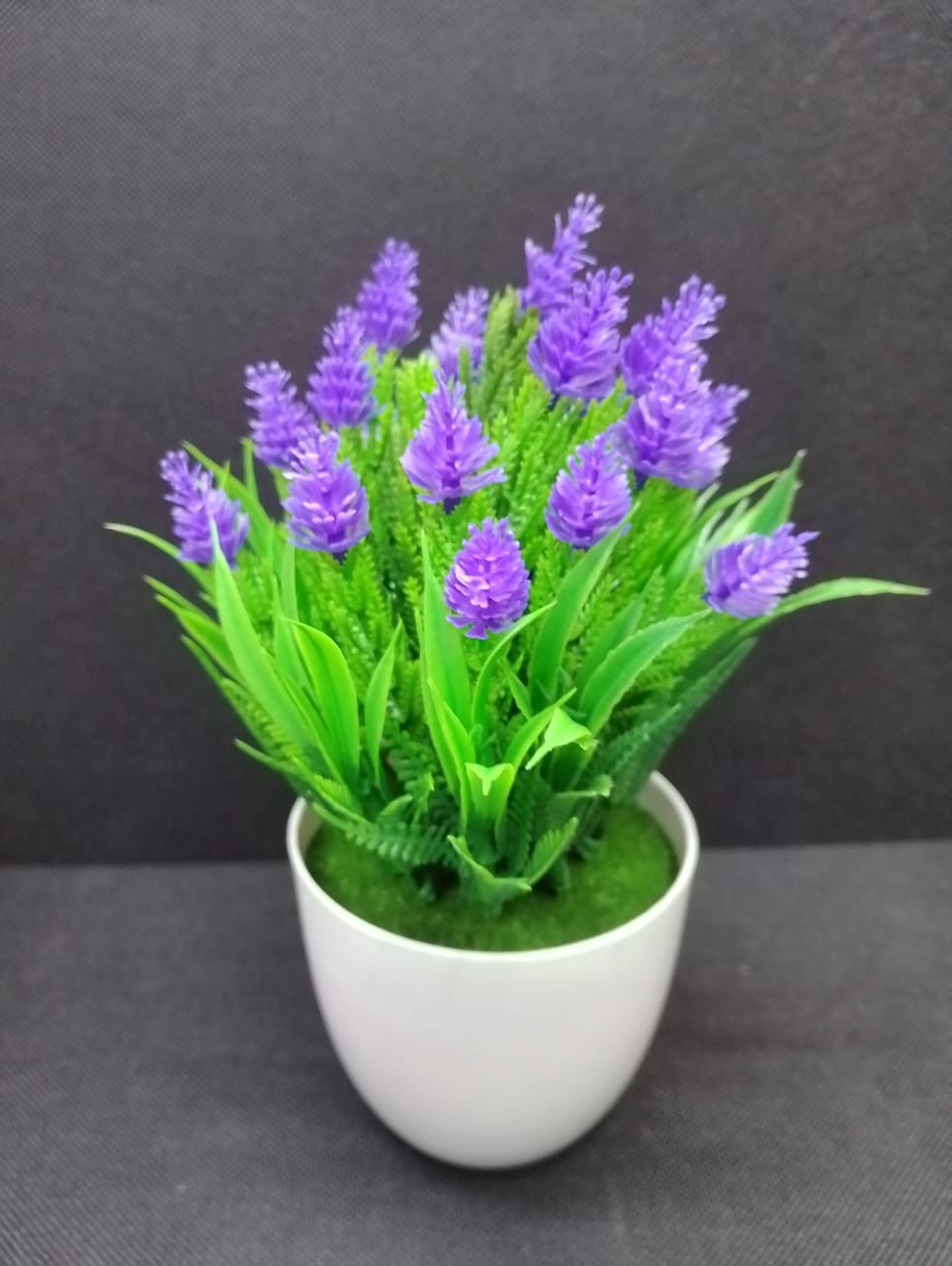 Artificial/ faux home decorative flower with vase (home decor/office table/bathroom decor/bedside table decor)  . The artificial plant needs low maintenance  since it requires no sunlight or water. It