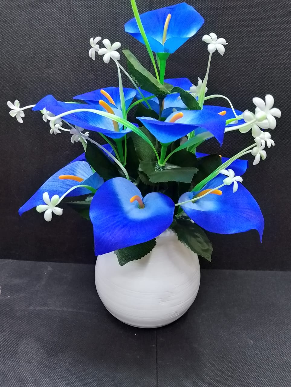 Artificicial Bail Table Top Flower   This beautifully piece adds a touch of nature and elegance to any room, creating a soothing and inviting atmosphere. The realistic design makes it a perfect piece