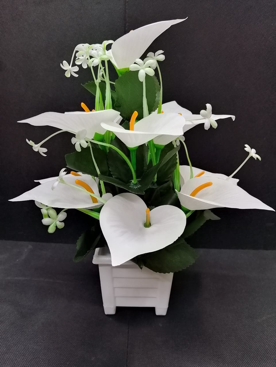 Artificicial Bail Table Top Flower   This beautifully piece adds a touch of nature and elegance to any room, creating a soothing and inviting atmosphere. The realistic design makes it a perfect piece