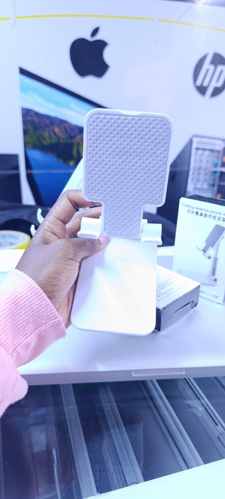 BRAND NEW FOLDABLE DESKTOP PHONE STAND HOLDER WHITE IN COLOR WITH A RUBBER HOLDER