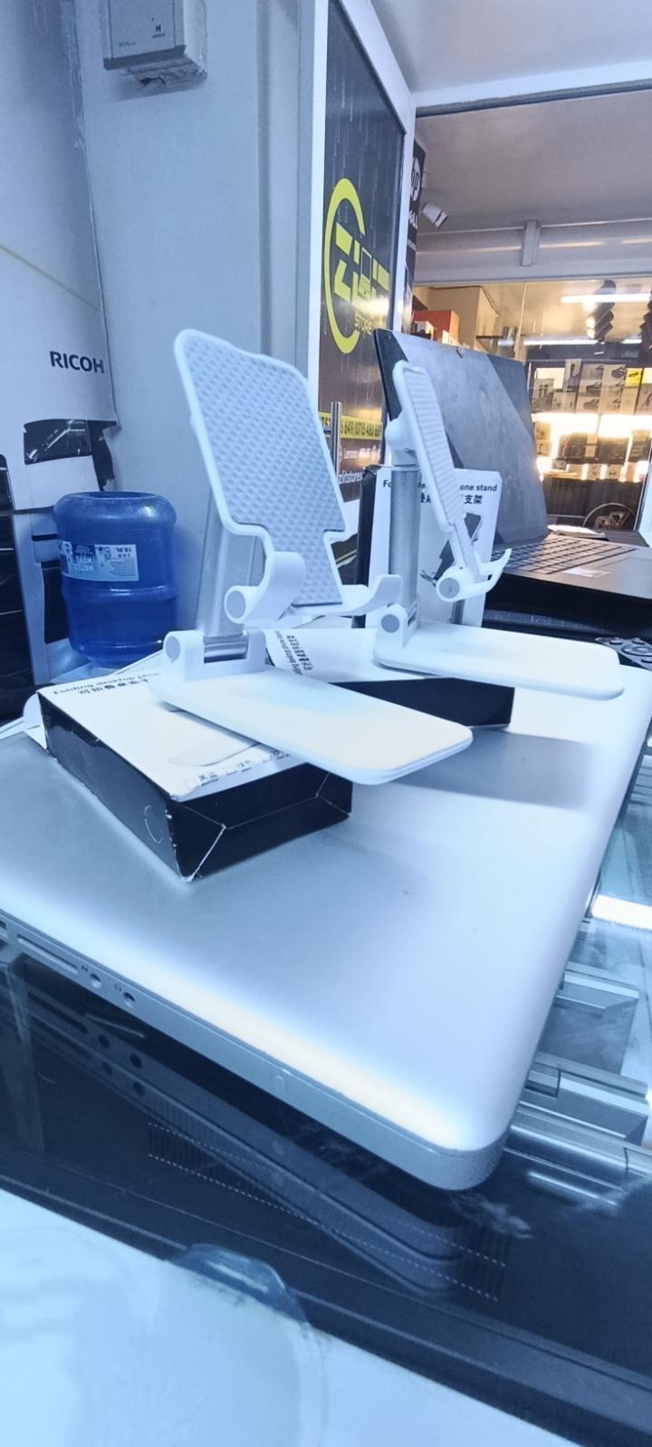 BRAND NEW FOLDABLE DESKTOP PHONE STAND HOLDER WHITE IN COLOR WITH A RUBBER HOLDER