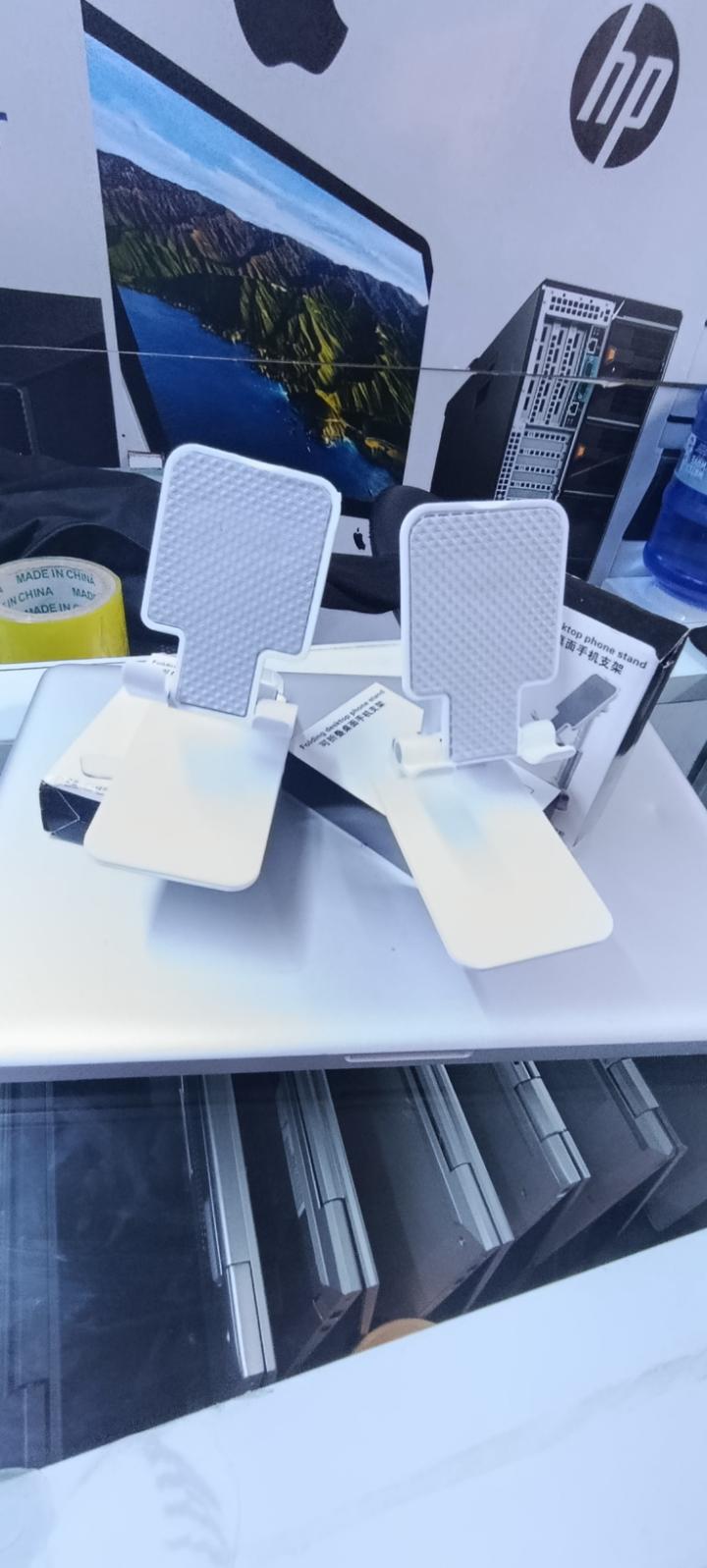 BRAND NEW FOLDABLE DESKTOP PHONE STAND HOLDER WHITE IN COLOR WITH A RUBBER HOLDER