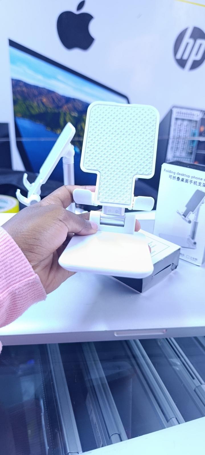 BRAND NEW FOLDABLE DESKTOP PHONE STAND HOLDER WHITE IN COLOR WITH A RUBBER HOLDER