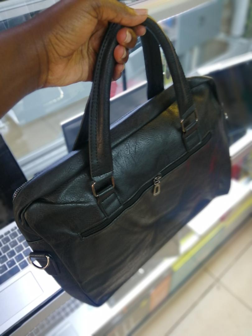 A sleek and spacious leather sling bag with a wide-zip design, perfect for laptops, travel, work, and daily use. Stylish, durable, and comfortable to carry