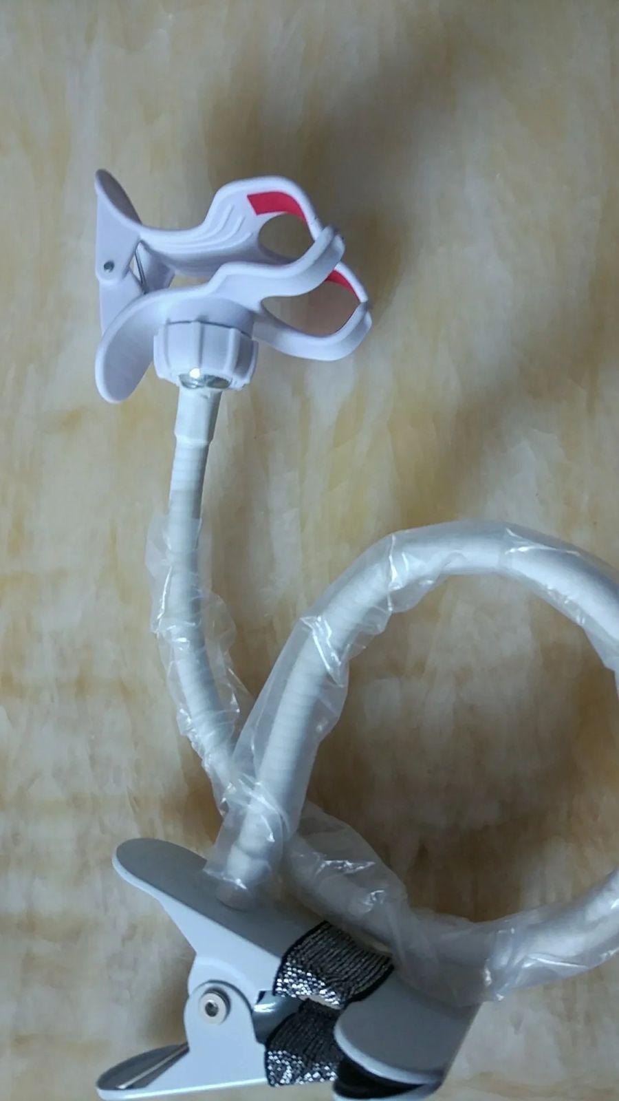 Metallic Flexible Phone Holder Stand Rotates 360 degrees ,hence flexible for all angleSuitable clips on edges of a table or flat surface The holder has a strong grip and can stretch