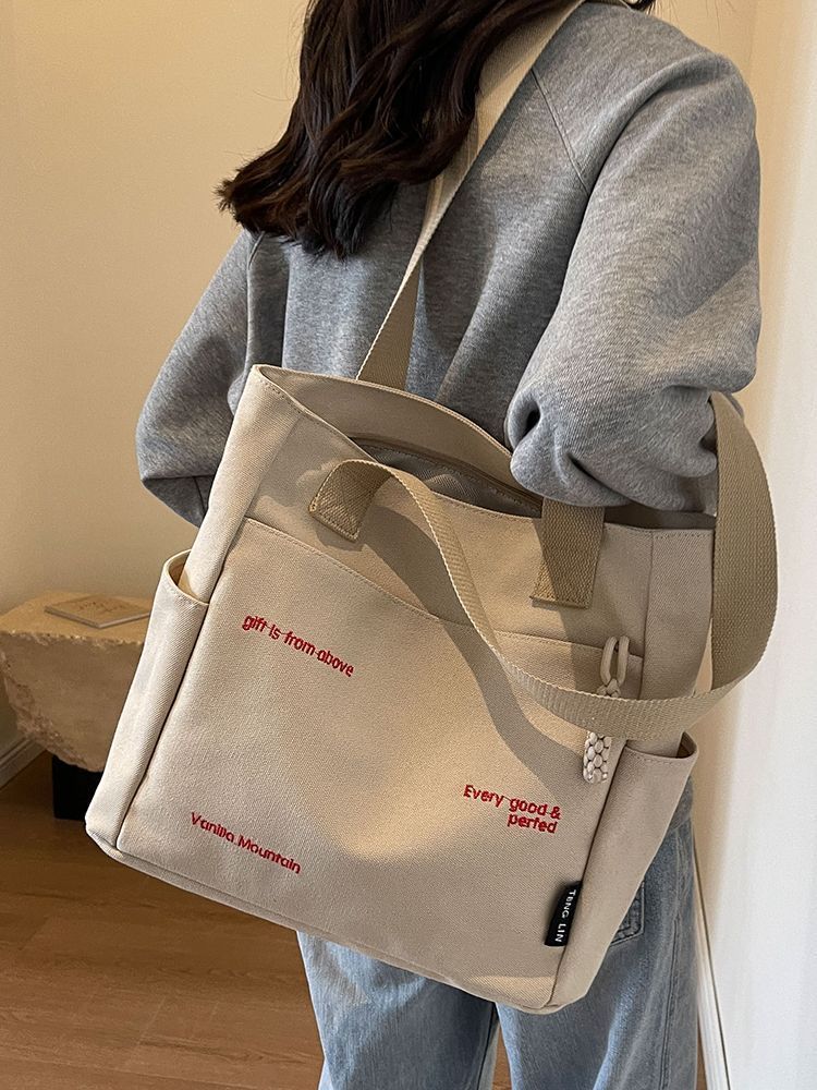 【Good Quality】Canvas bag women's men's new trendy embroidery letter handbag student large capacity single shoulder tote bag office commuter crossbody bag