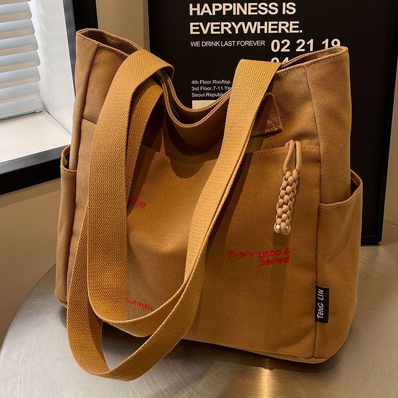 【Good Quality】Canvas bag women's men's new trendy embroidery letter handbag student large capacity single shoulder tote bag office commuter crossbody bag