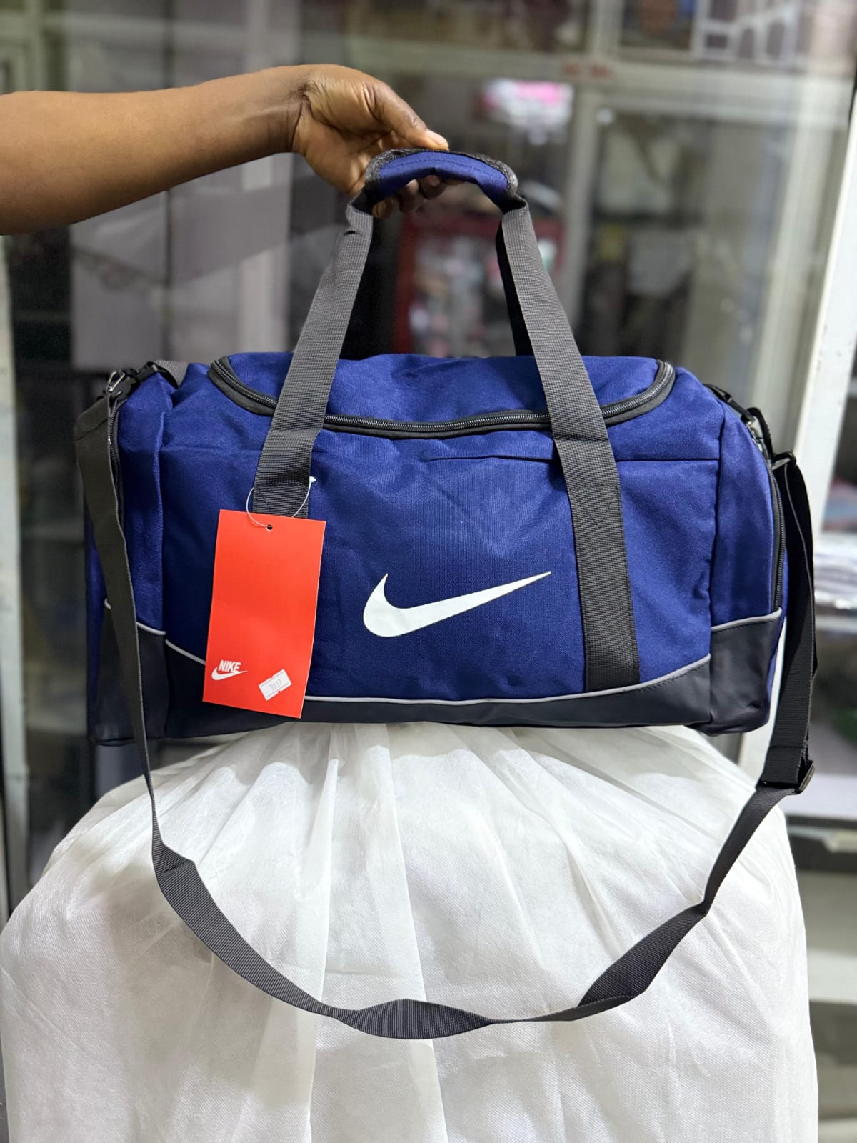 NEW IN 🔥🔥🔥Nike Duffle /gym Bag
✅ Spacious design with separate shoe compartment
✅Has a wet clothes compartment on the inside 
✅well partitioned 
📏 dimensions: 50cm (L) x 25cm (W) x 28cm (H)
🧳 Id
