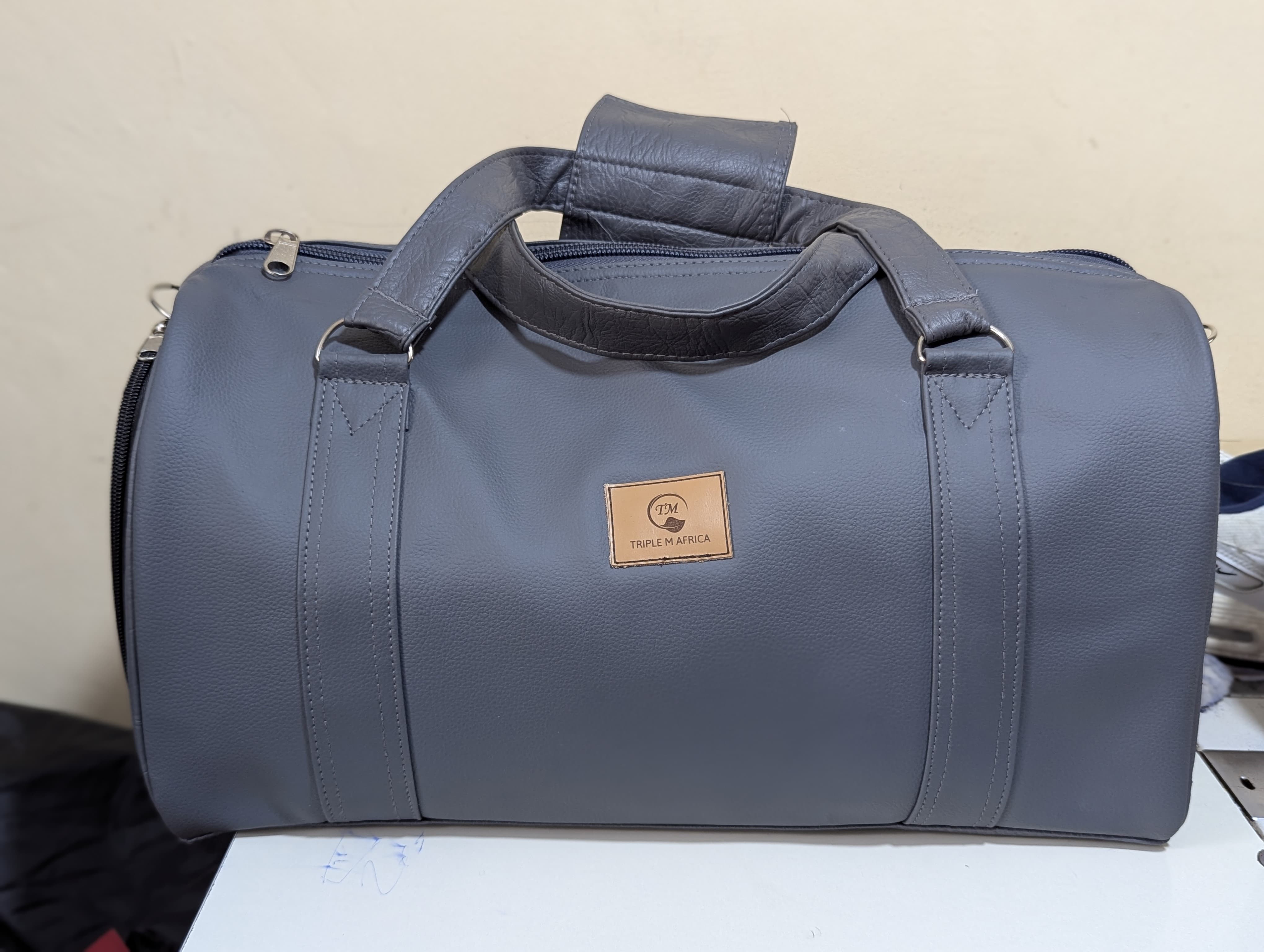 GYM BAG ⚡Water proof leather travel bag with a shoe pocket special only for a pair of shoe⚡and a laptop compart pocket inside , Easy to carry either by hand or shoulder an also at backside😍colours😍