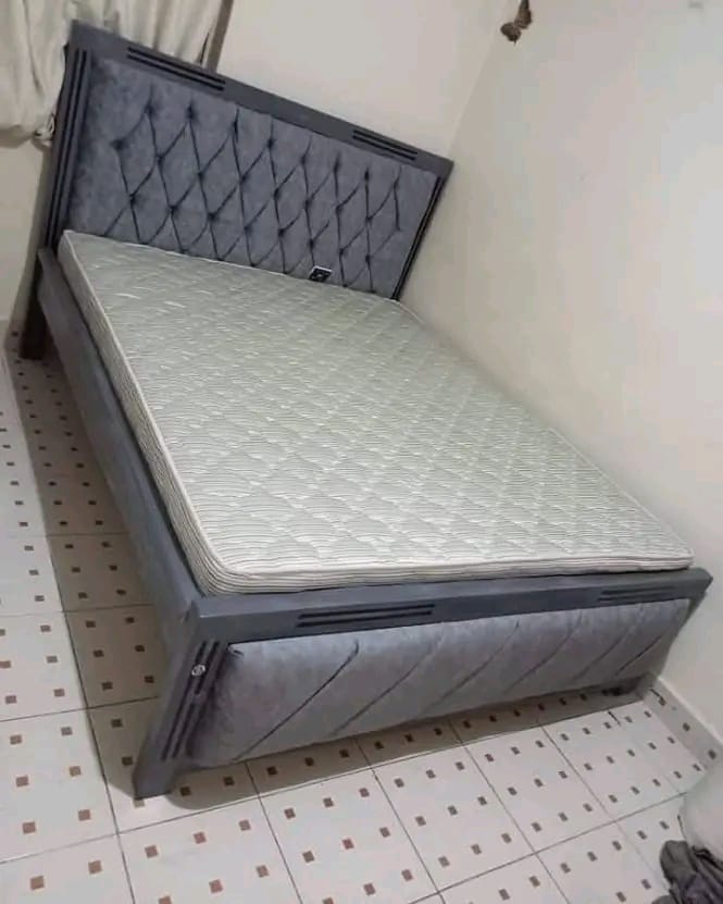 Mocket bed frame with a tufted upholstered headboard