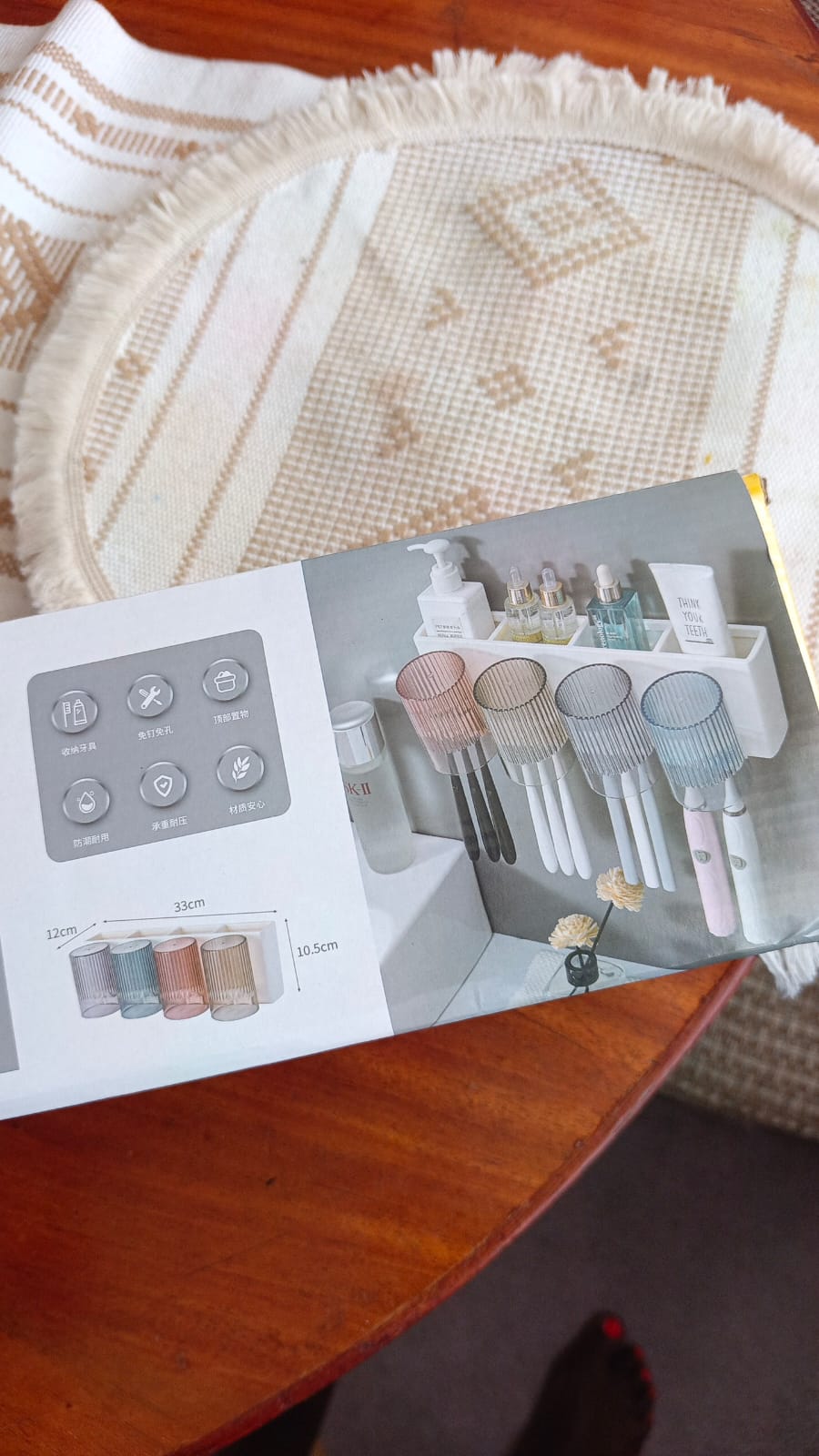 wall-mounted bathroom organizer set includes a toothbrush holder, automatic toothpaste dispenser, and four magnetic cups.     Organization: Features a storage compartment for toothpaste, soap, razors,