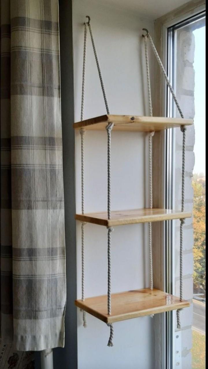 Three tiers of natural  wood floating shelves Durable rope for a rustic, suspended look