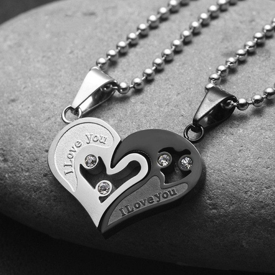 A pair of heart-shaped diamond-encrusted pendants with a bead chain love couple necklace