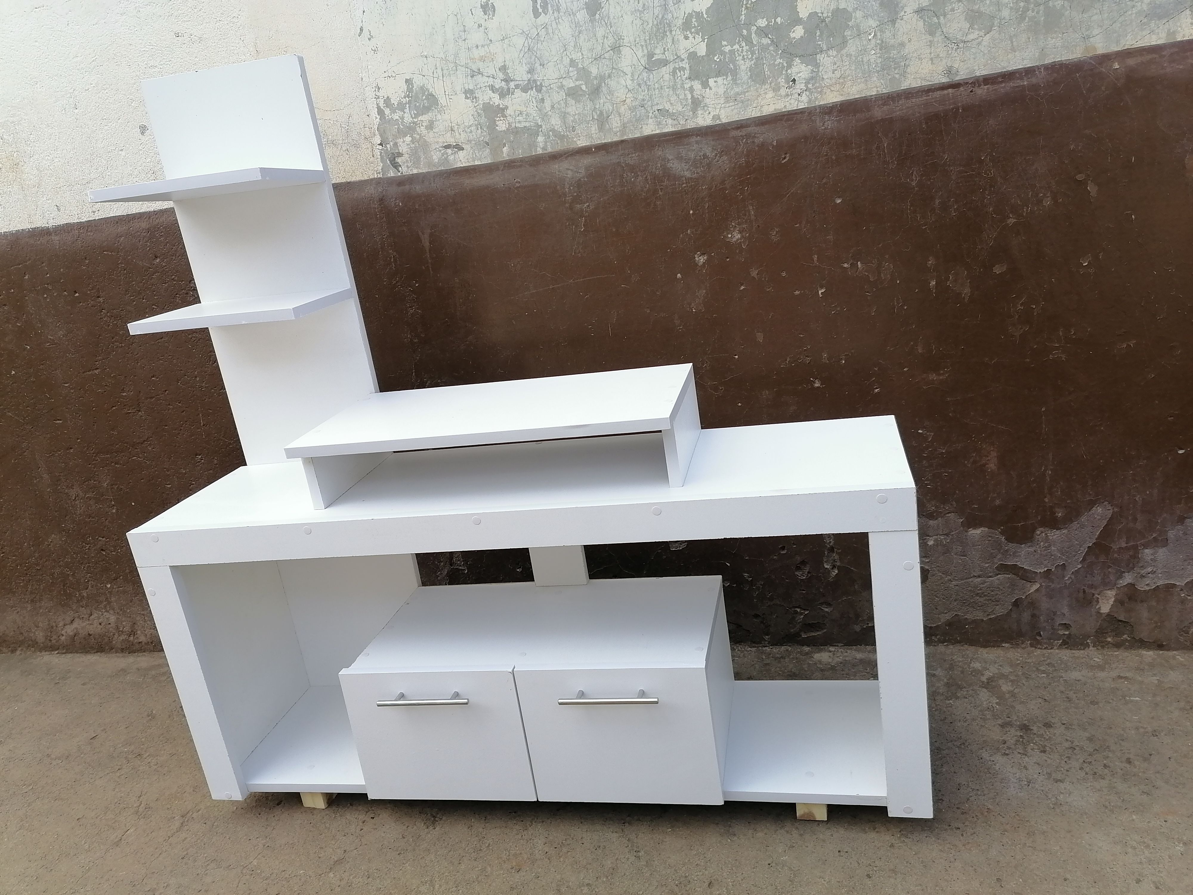 Media Consoles With Integrated Storage Neatly Organized And Display Media Equipment Like TVs, Gaming Consoles, And Sound Systems. They Feature Open Shelves, Closed Cabinets, And Drawers.