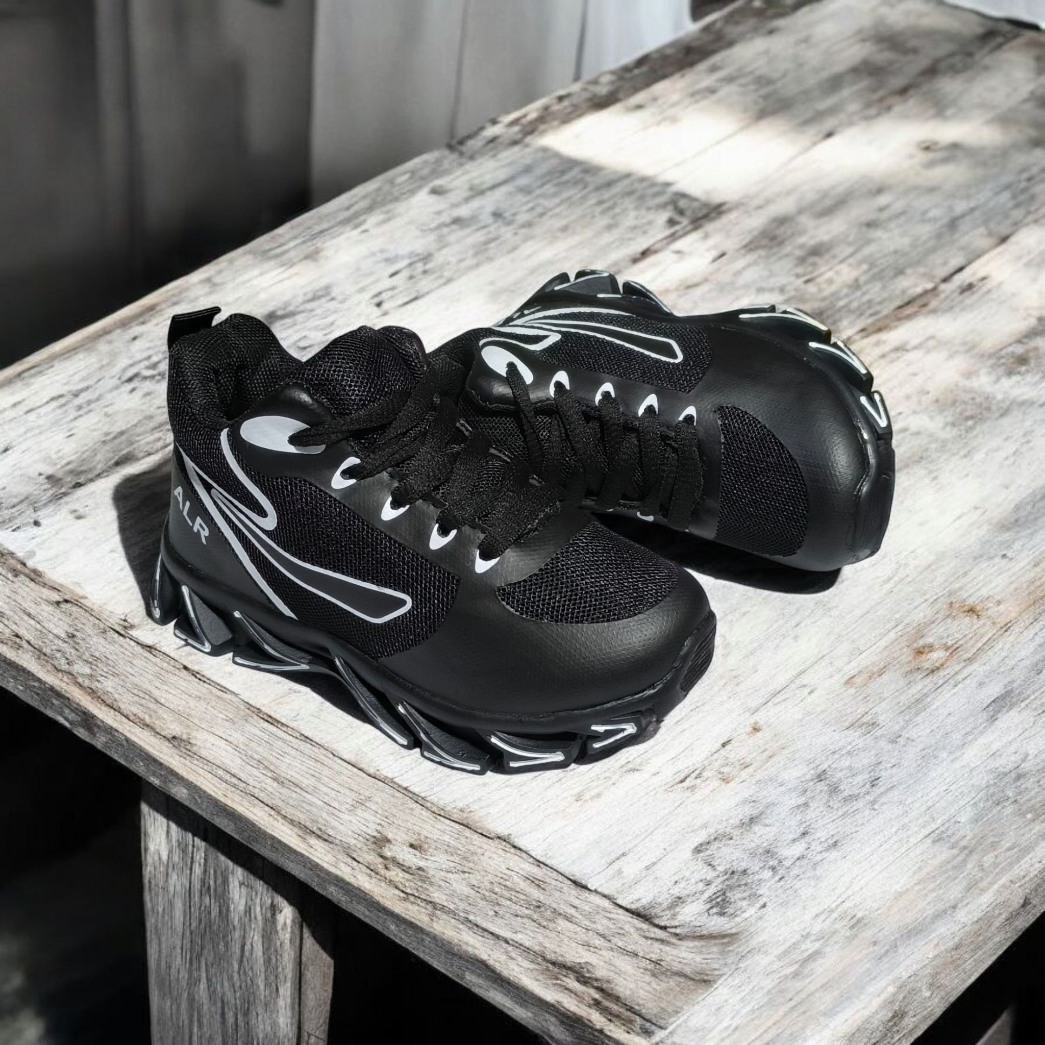 ALR V-Design Athletic kids Shoes. The shoes feature a black color scheme with white, gold,red and orange accents. Suitable for sports and averyday wear.