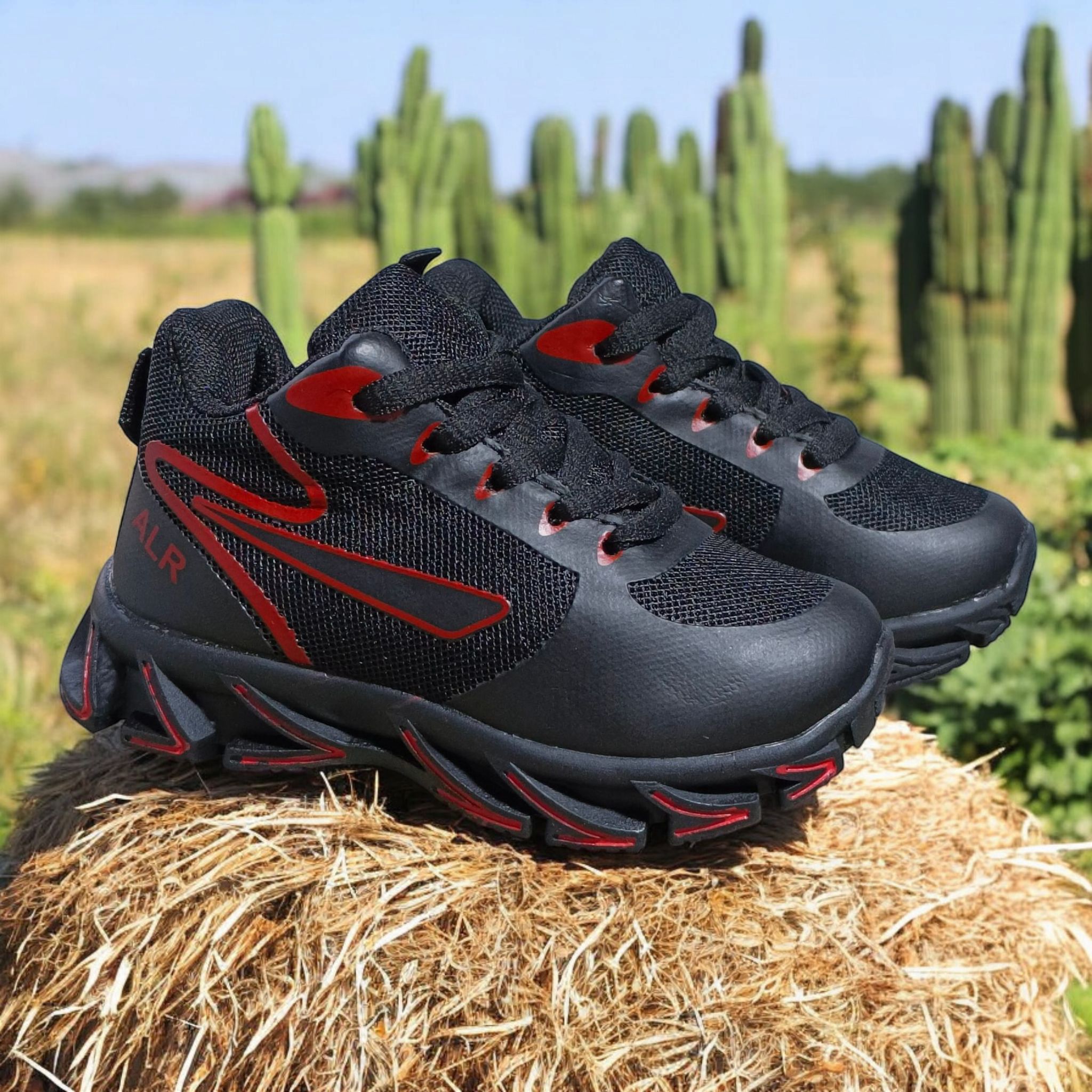 ALR V-Design Athletic kids Shoes. The shoes feature a black color scheme with white, gold,red and orange accents. Suitable for sports and averyday wear.