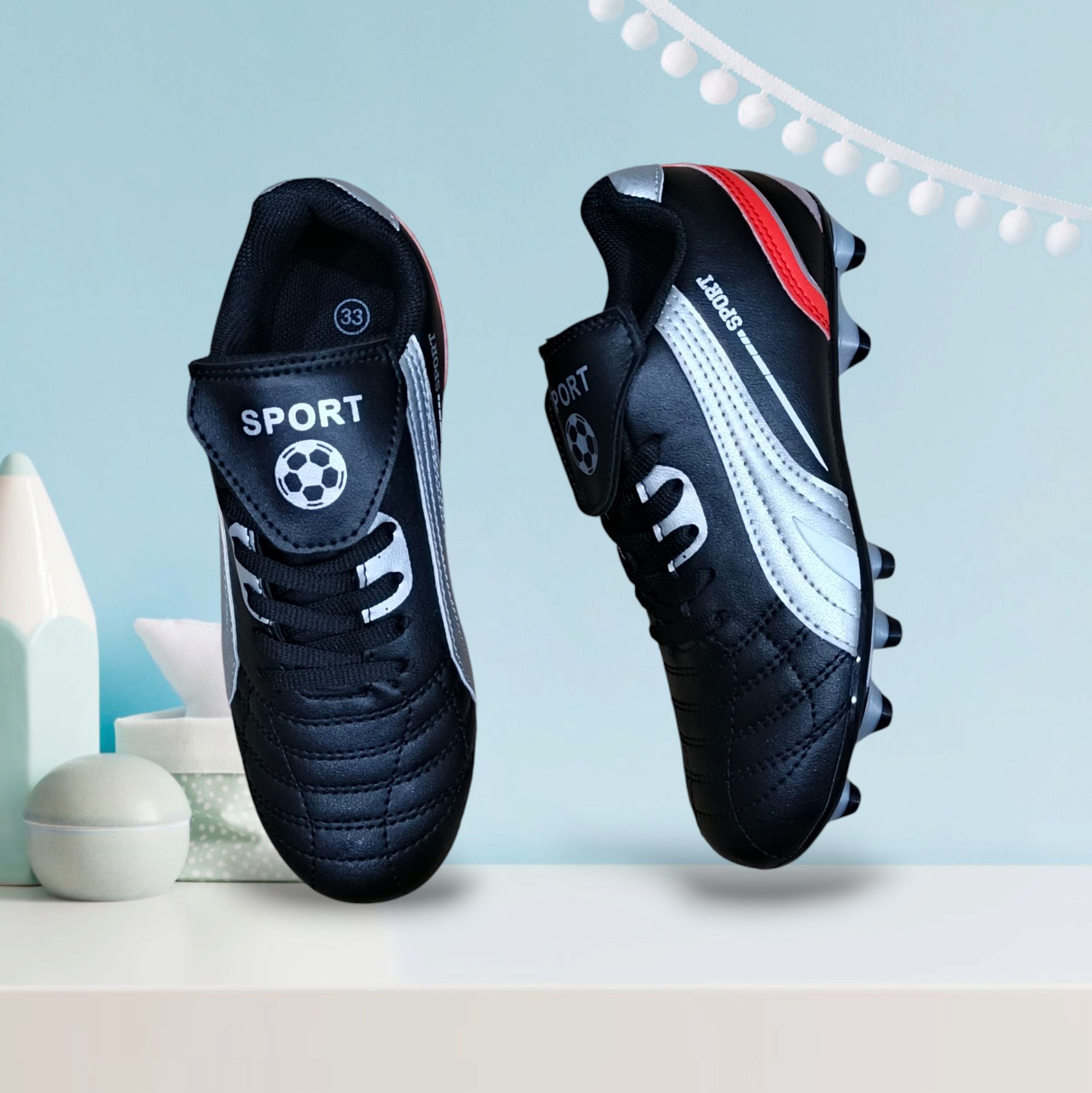 KIDS SOCCER BOOTS. A PAIR OF SOCCER CLEATS; FOOTBALL BOOTS.