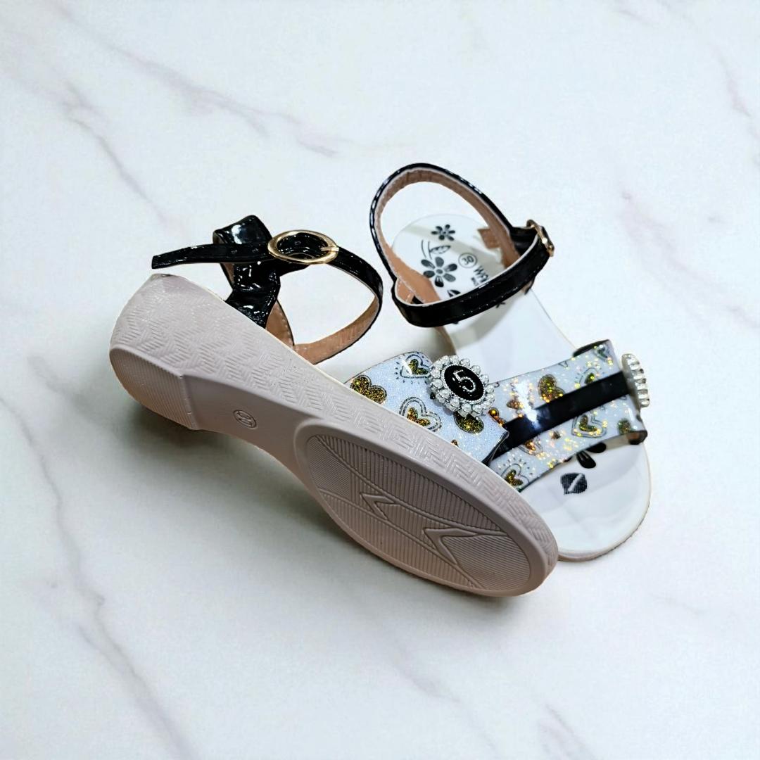 Girls summer sandals with straps and flower charm. Cute shimmering Colors and black ankle straps.