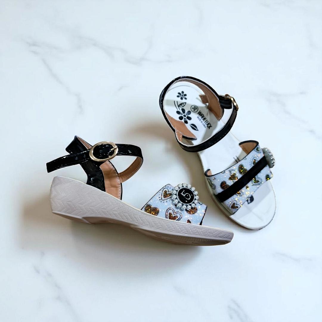 Girls summer sandals with straps and flower charm. Cute shimmering Colors and black ankle straps.