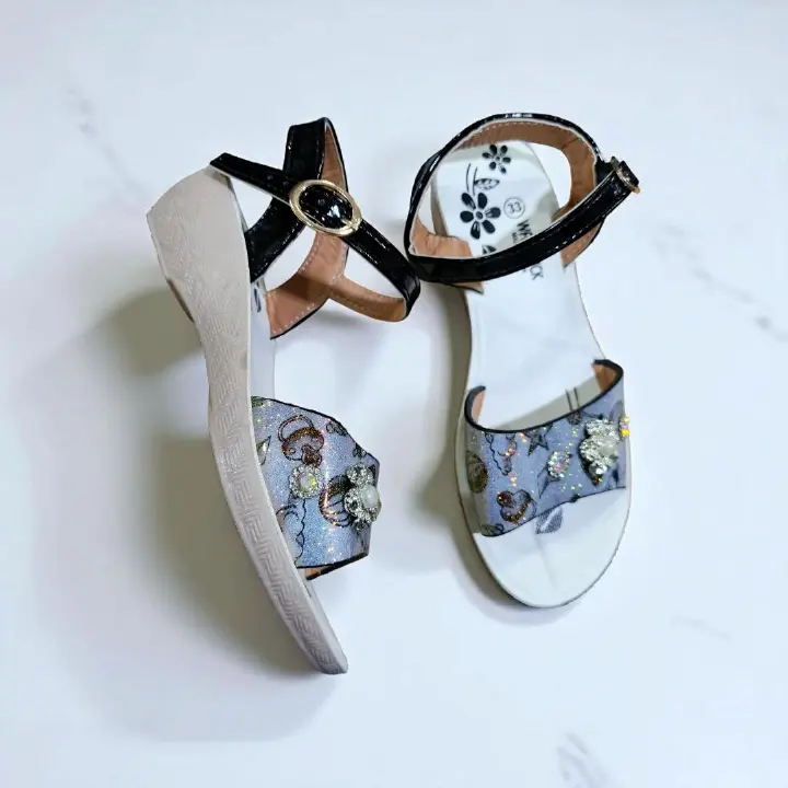 Girls summer sandals with straps and flower charm. Cute shimmering Colors and black ankle straps.