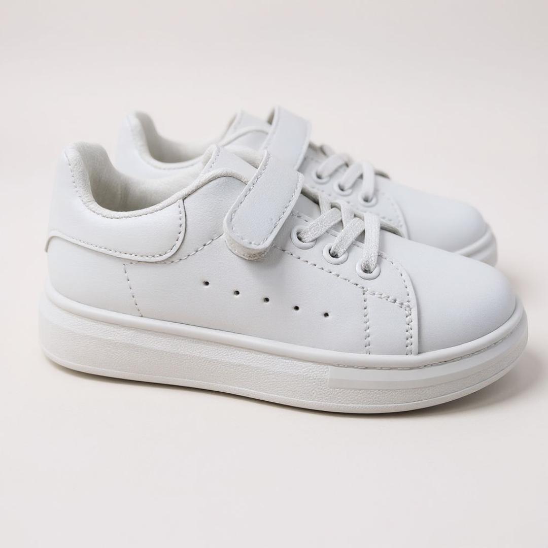 Classic white sneakers. Comfortable , versatile kids white sport shoes. School casual, minimalist, sporty white sport shoes. Clean and fresh look of a white sneaker.