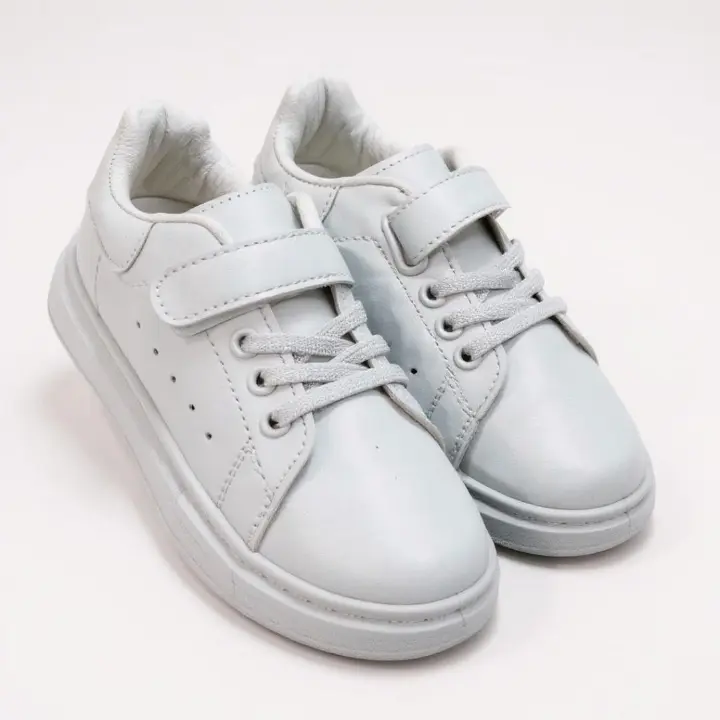Classic white sneakers. Comfortable , versatile kids white sport shoes. School casual, minimalist, sporty white sport shoes. Clean and fresh look of a white sneaker.