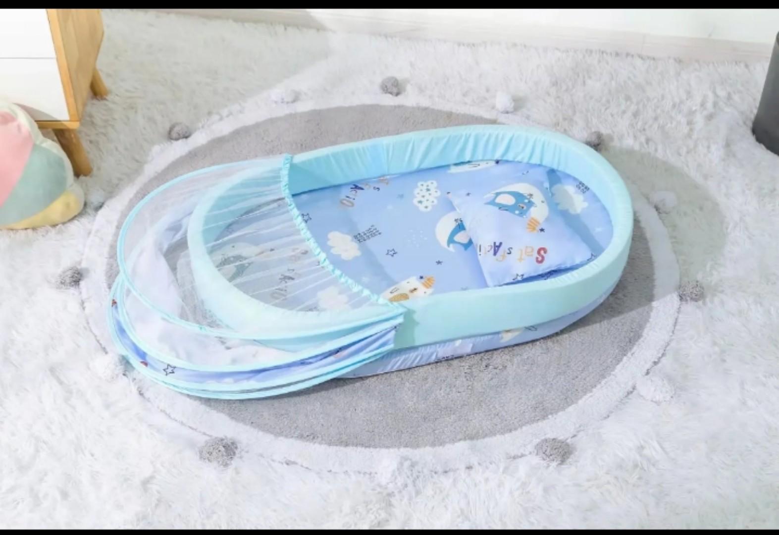 Portable baby bed with an integrated mosquito net head pillow designed for infant sleep and protection