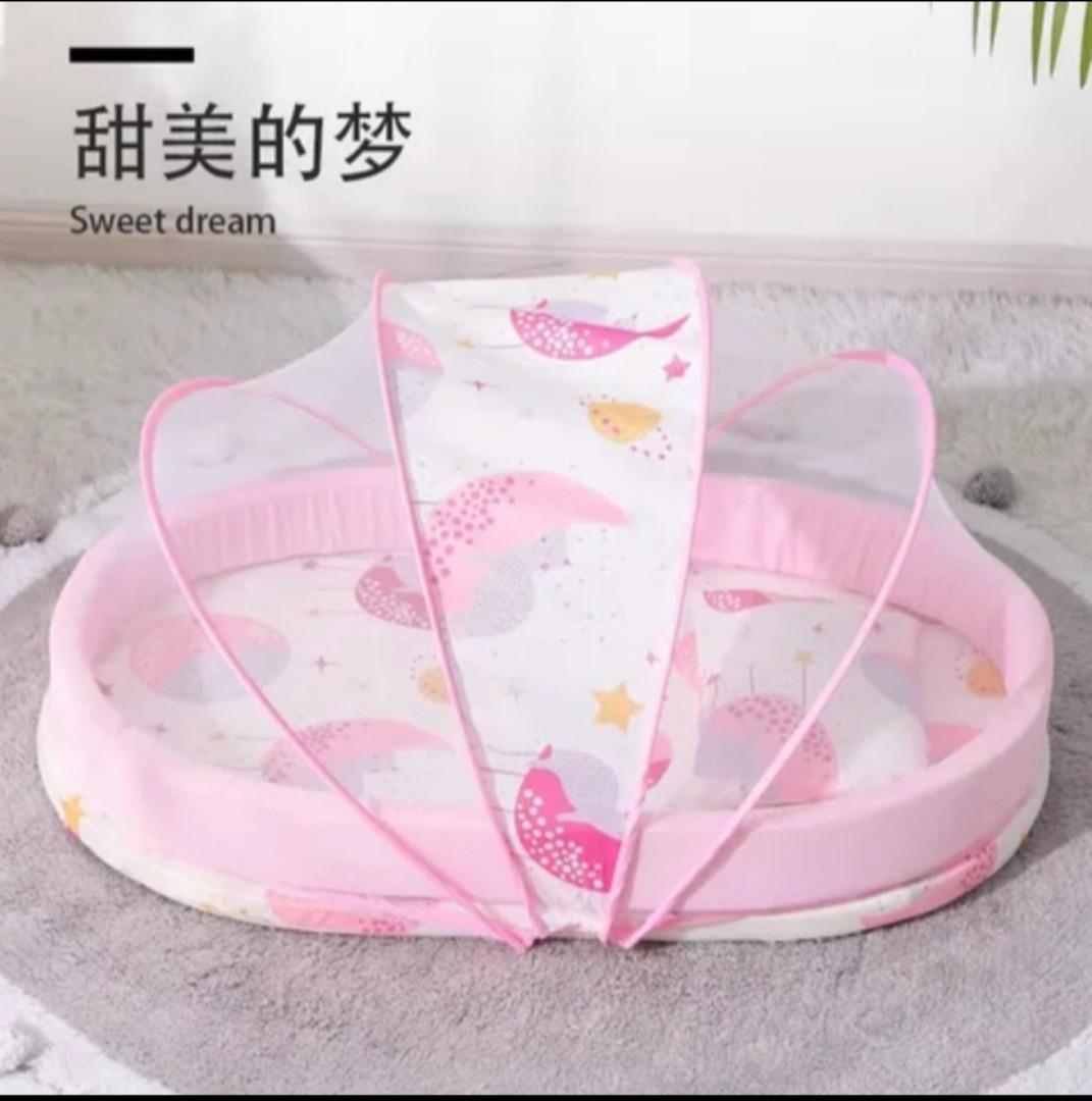 Portable baby bed with an integrated mosquito net head pillow designed for infant sleep and protection