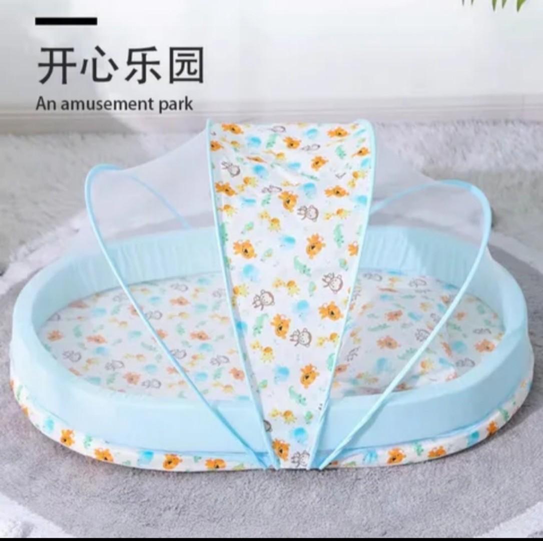 Portable baby bed with an integrated mosquito net head pillow designed for infant sleep and protection