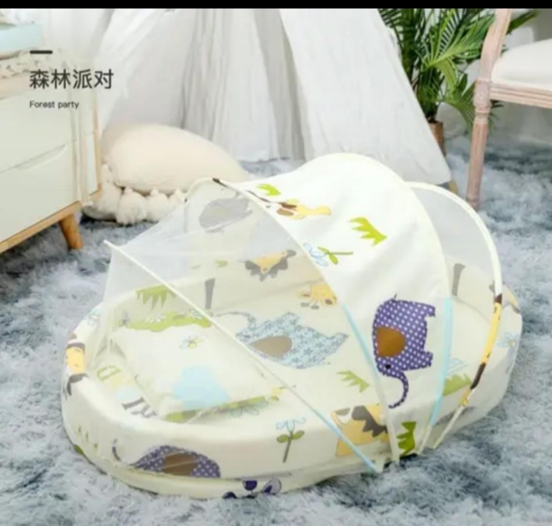Portable baby bed with an integrated mosquito net head pillow designed for infant sleep and protection