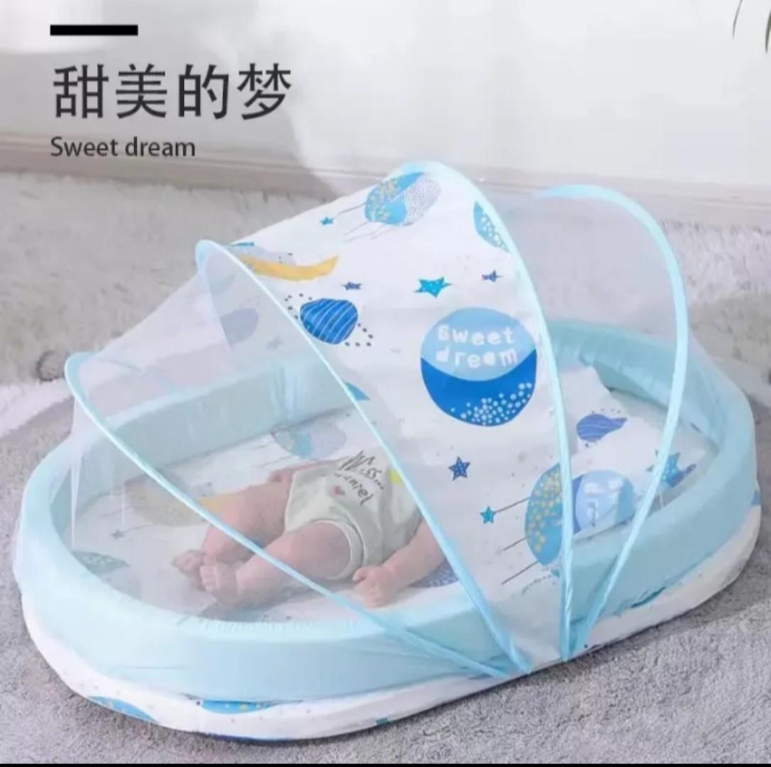 Portable baby bed with an integrated mosquito net head pillow designed for infant sleep and protection