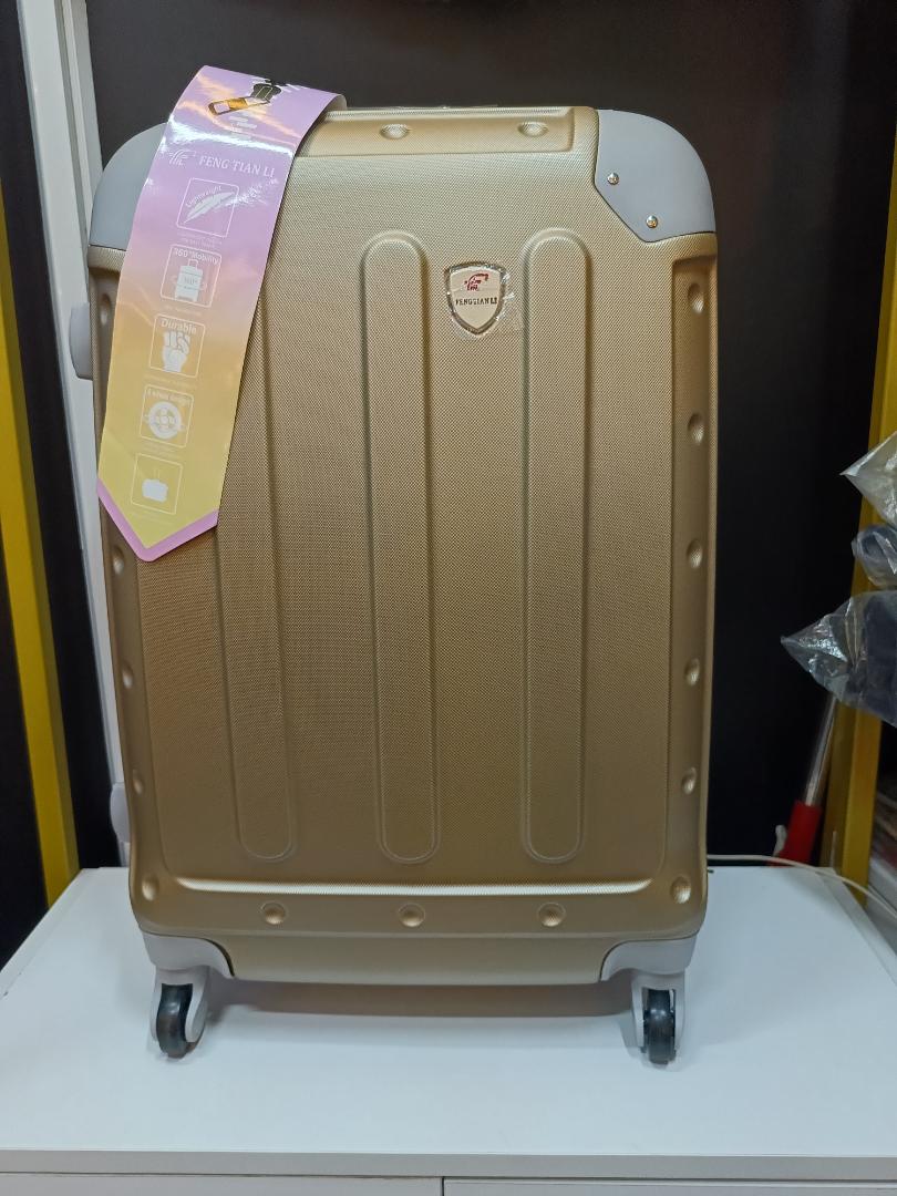 Medium golden travelling suitcase