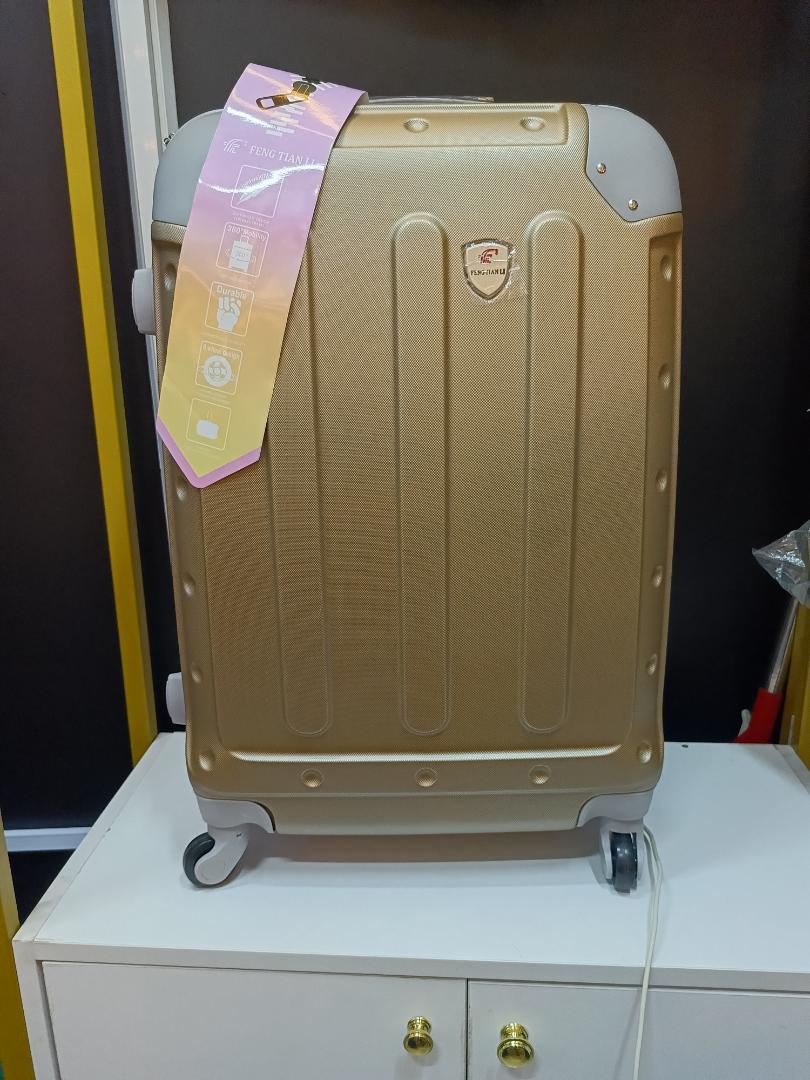 Medium golden travelling suitcase