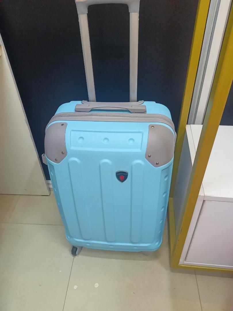 small fibre light blue suitcase with grey corners.