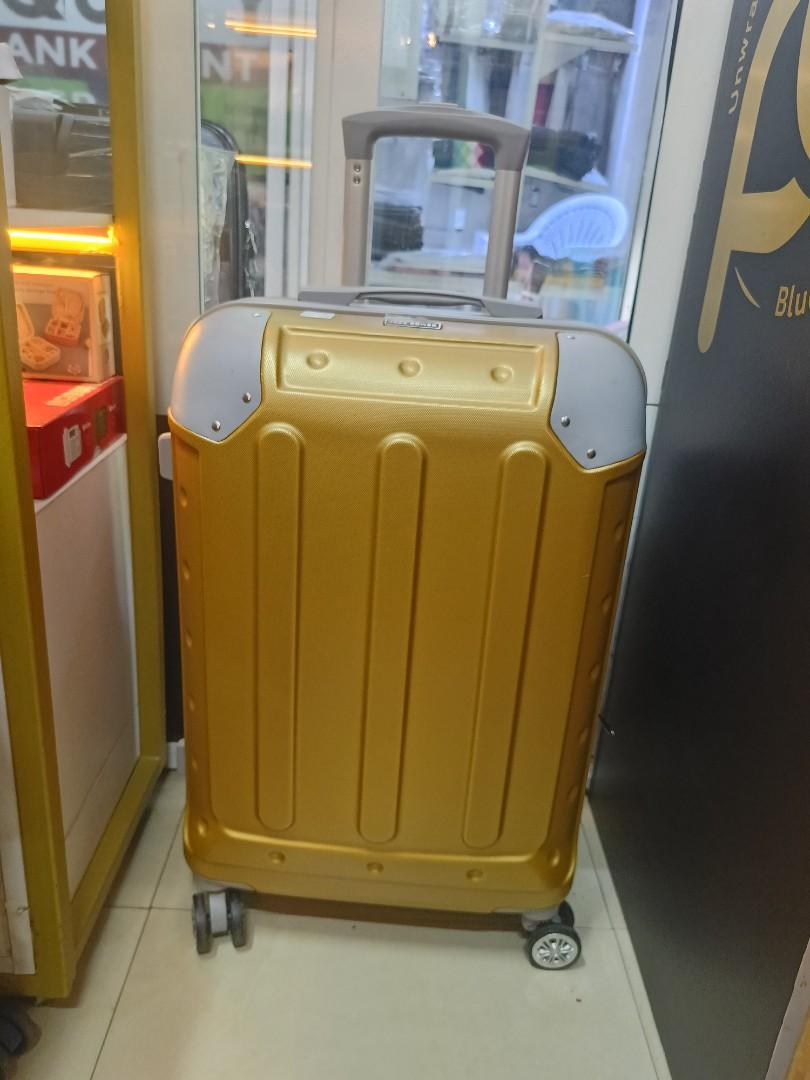 small gokden fibre suitcase with grey corners and with measure of H 47, W 33, L 23