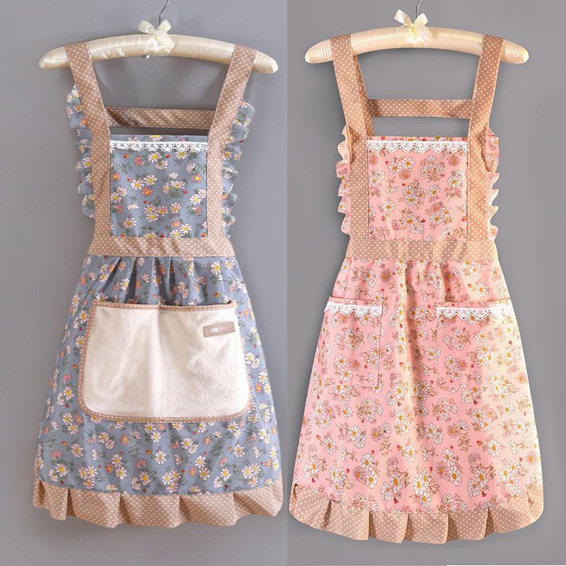 2 pcs aprons in packing. In a suspender design, they come in soft colors - blue and pink - adorned with small floral patterns. Ruffled edges add a sweet touch