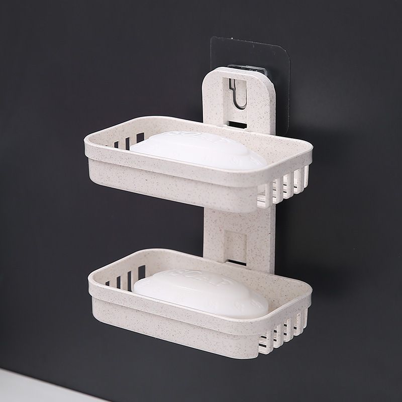 bathroom storage rack, double - layer design, plastic material, wall - mounted type. Used for storing bath supplies like soap, helps save space.