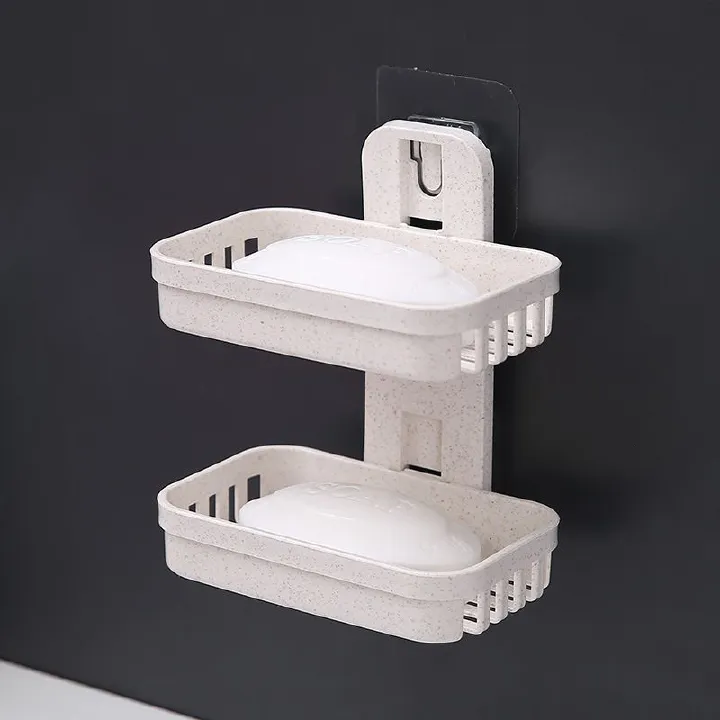 bathroom storage rack, double - layer design, plastic material, wall - mounted type. Used for storing bath supplies like soap, helps save space.