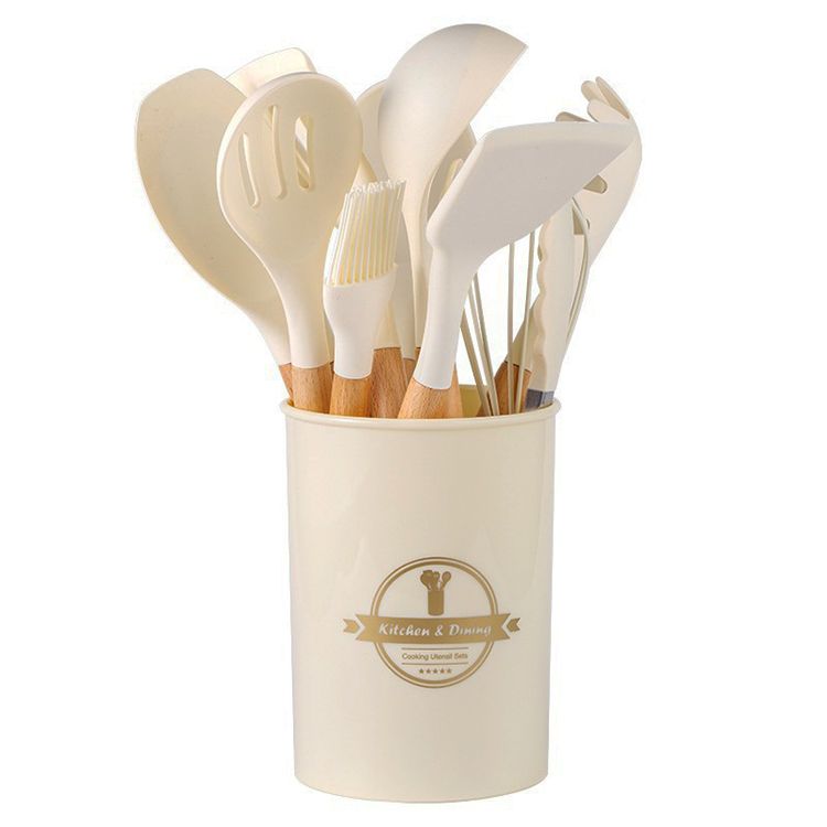 This is a set of silicone kitchen utensils, including spatulas and spoons, stored in a branded container. Heat - resistant and non - stick, they protect cookware from scratches.。