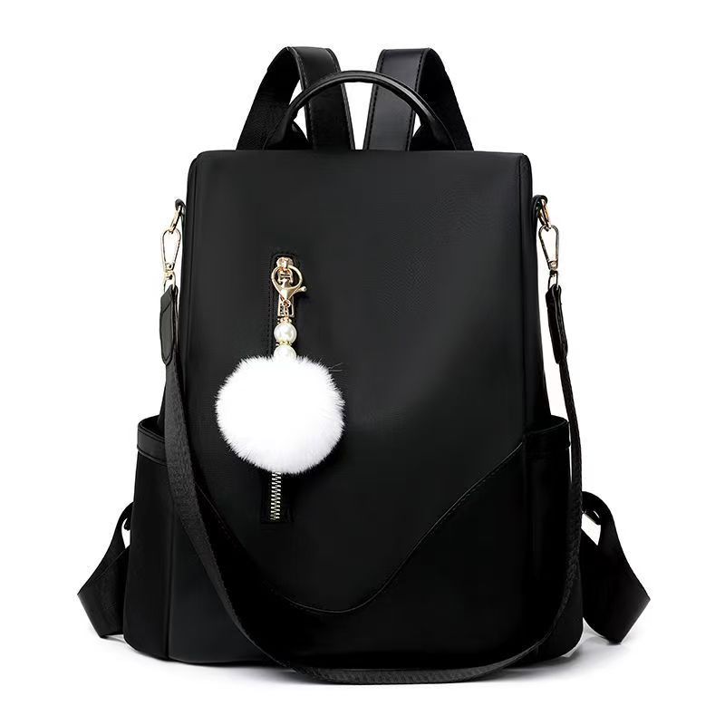 Trendy women’s backpack: white pom-pom charm, adjustable straps. Spacious, stylish & versatile—perfect for Kenyan young ladies’ daily outings/work.