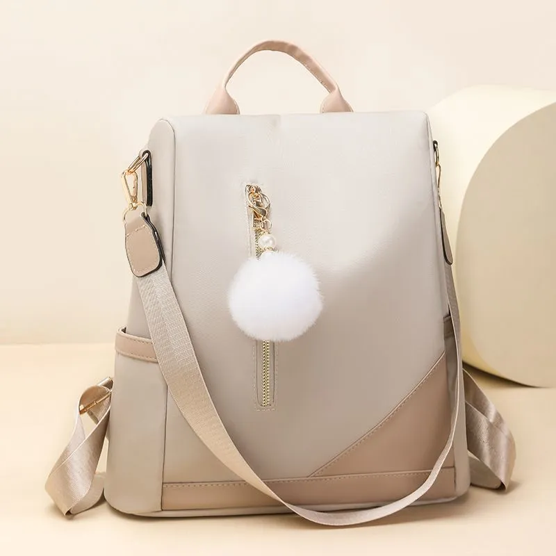 Trendy women’s backpack: white pom-pom charm, adjustable straps. Spacious, stylish & versatile—perfect for Kenyan young ladies’ daily outings/work.