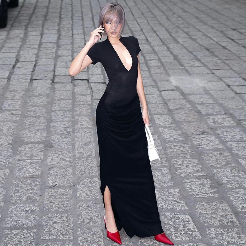 New elegant and sexy long dress for guests at evening banquets in the summer of 2025. It features a deep V-neck, short sleeves, a solid color, a form-fitting silhouette and pleats.