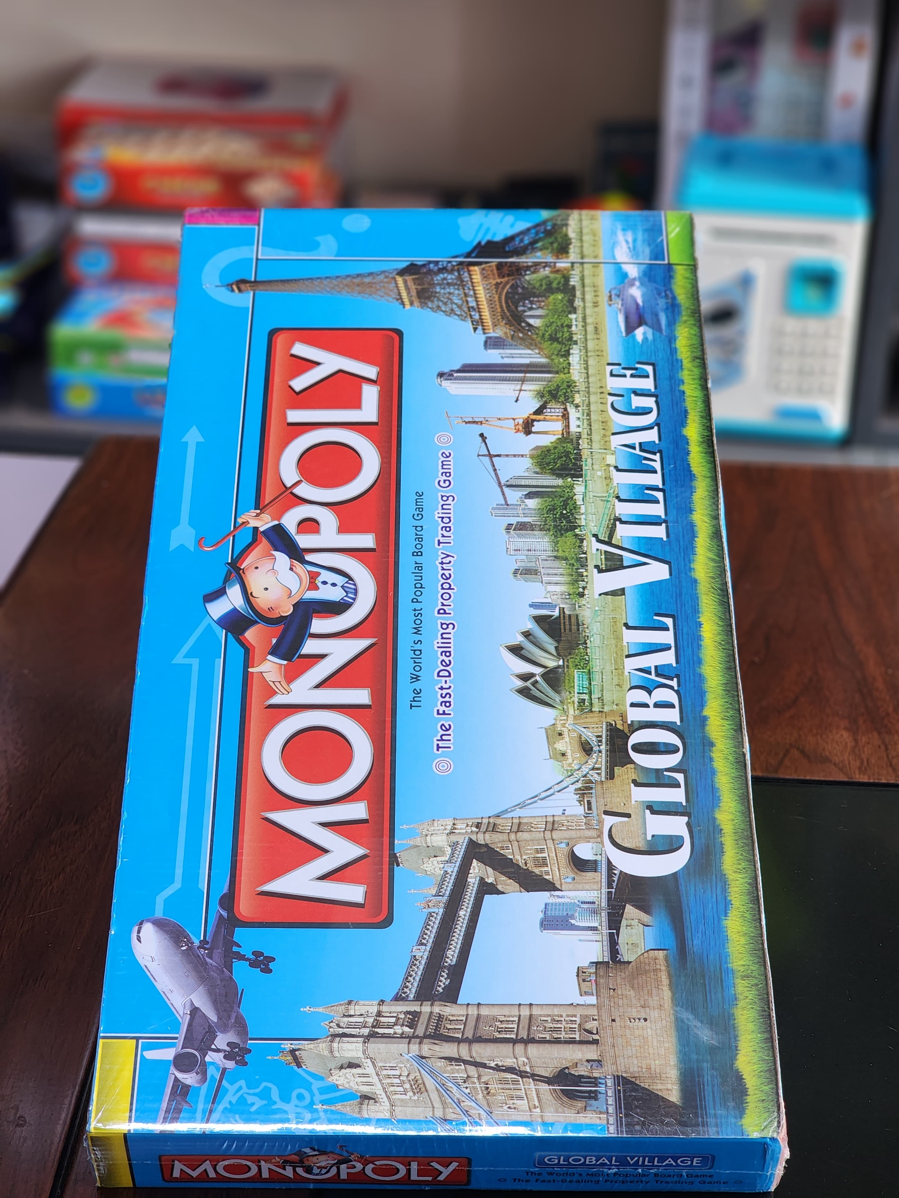 Monopoly Global Village Board Toys & Games Game paper board (foldable) 6 Token 28 Title Deed Cards 16 Chance cards 16 community chest Cards 1 pack of Monopoly money 32 houses 12 hotels large size