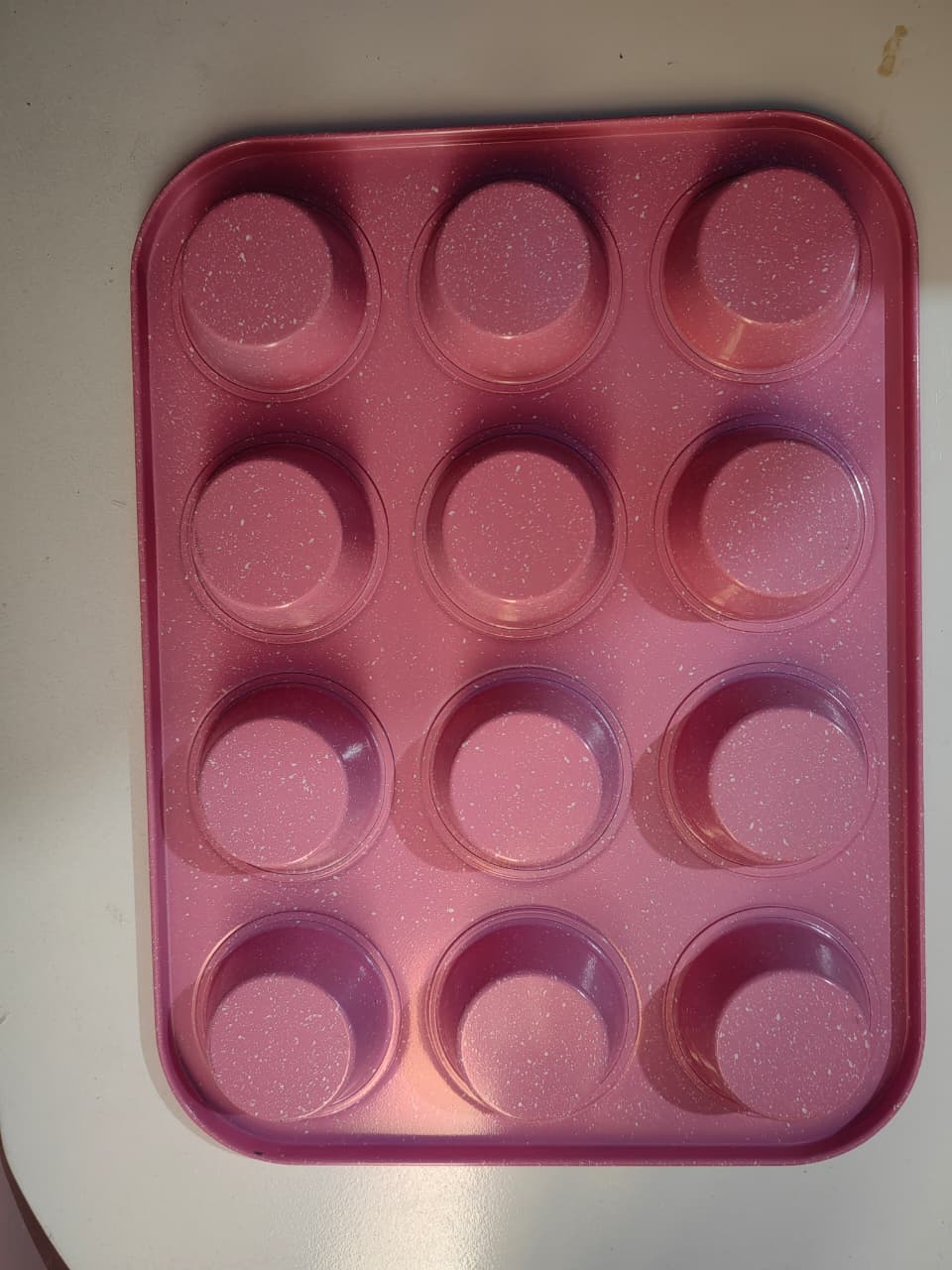 GOODCOOK MEGAGRIP 12-CUP MUFFIN PAN WITH SILICONE GRIP HANDLES PERFECT FOR CUPCAKES DURABLE HEAVY-GAUGE STEEL CONSTRUCTION SCRATCH-RESISTANT NONSTICK COATING PINK