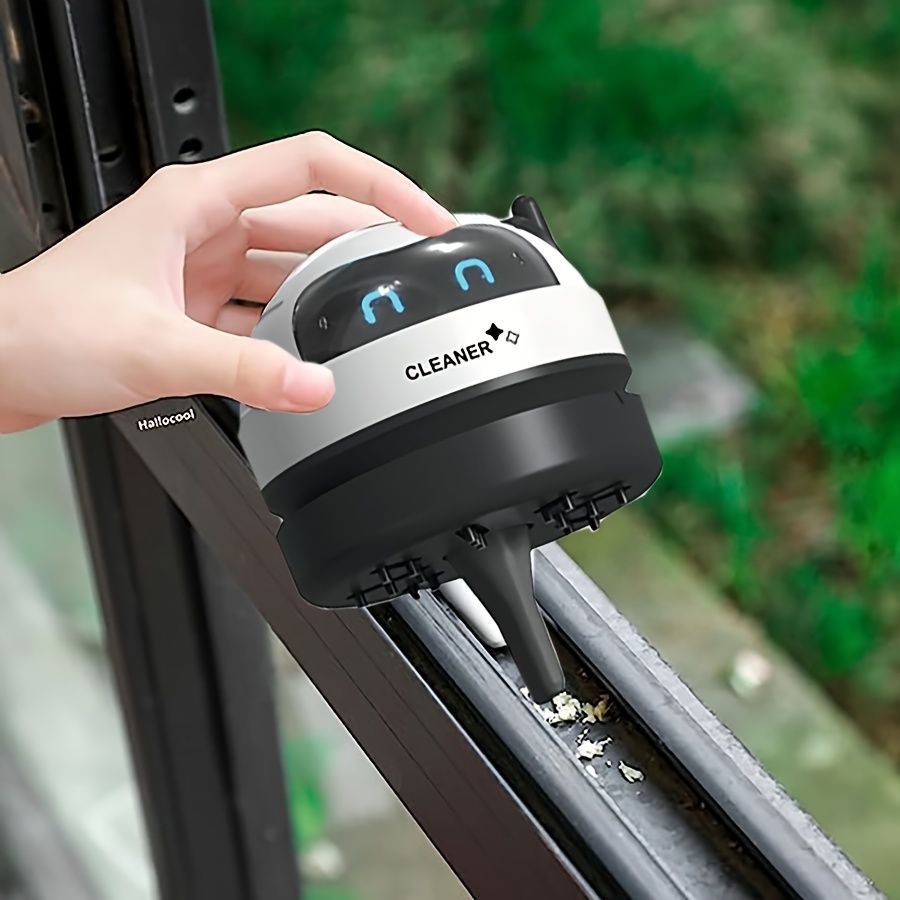 A Mini Desktop Vacuum Cleaner, Portable And Small, Powered by a Rechargeable USB Battery, Featuring a Cute Robot Design for Cleaning Desks Quietly, Picking Up Small Items Like Eraser Shavings And Debr