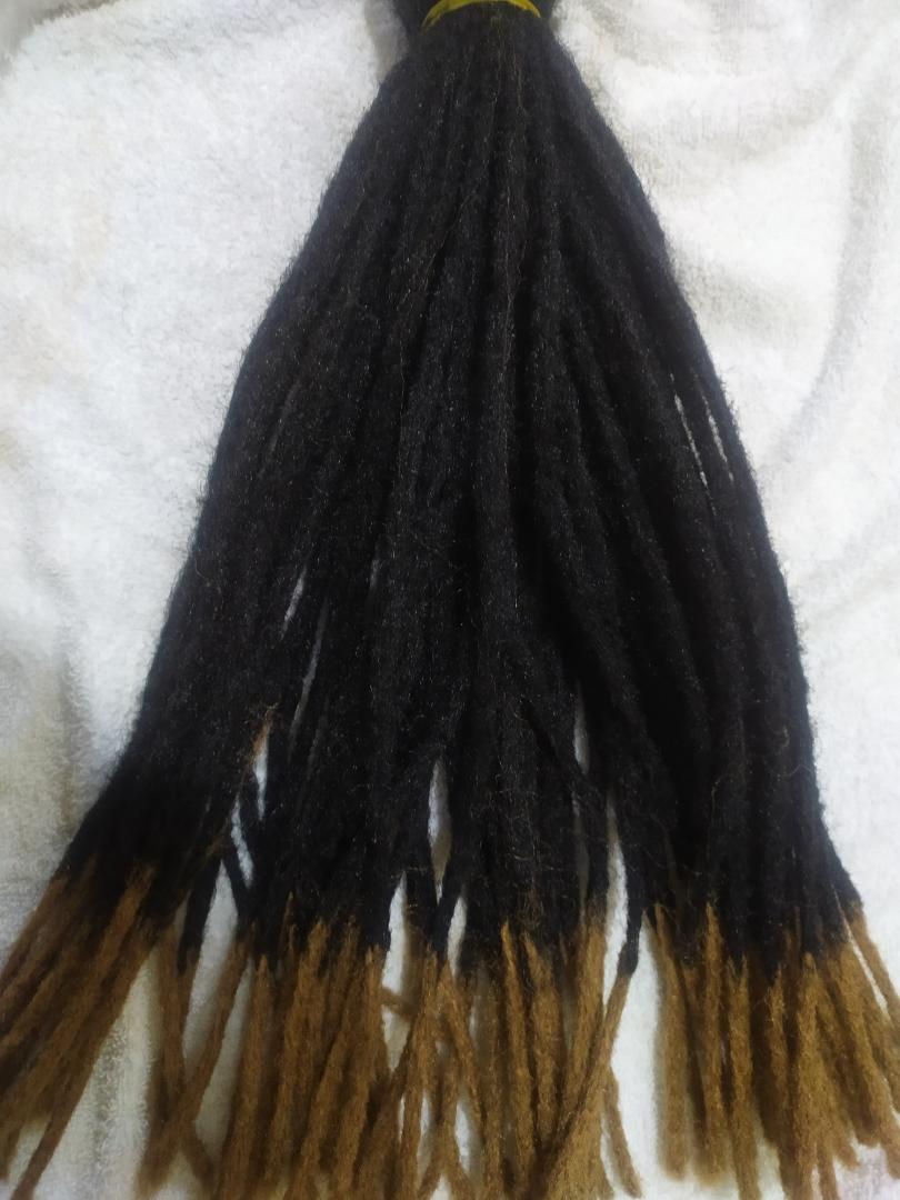 Synthetic Dreadlocks fall into the hair extensions category because the individual locs are attached to your natural hair. This can be accomplished by the extensions being braided or twisted in, from