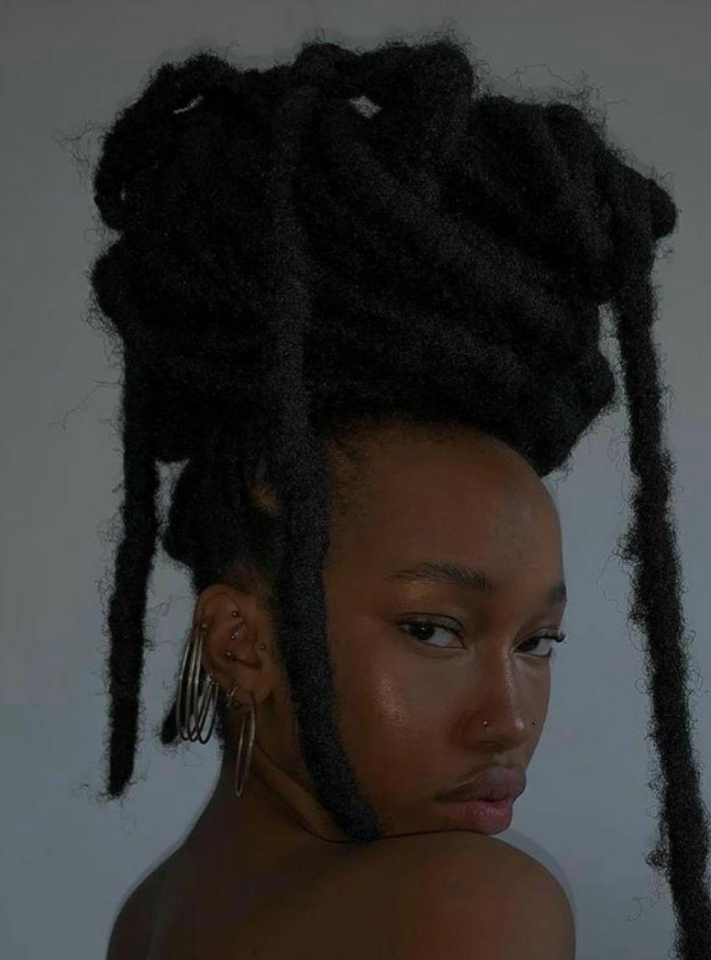 Riri locs are a bold variation of faux locs, known for their thicker, chunkier appearance. This style exudes confidence and a carefree flair, often featuring a slightly undone, textured finish. These