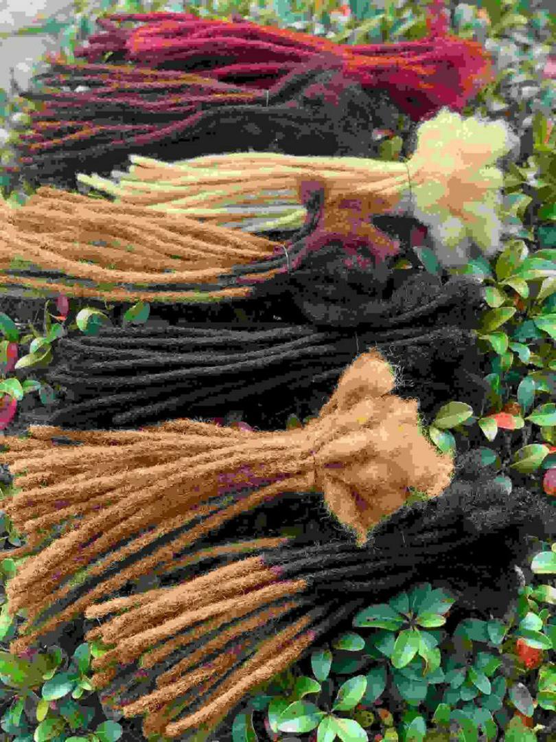 Artificial dreadlock extensions are pre-made dreadlock-like strands, typically made of synthetic hair, that are attached to natural hair to create the appearance of dreadlocks without the long-term co
