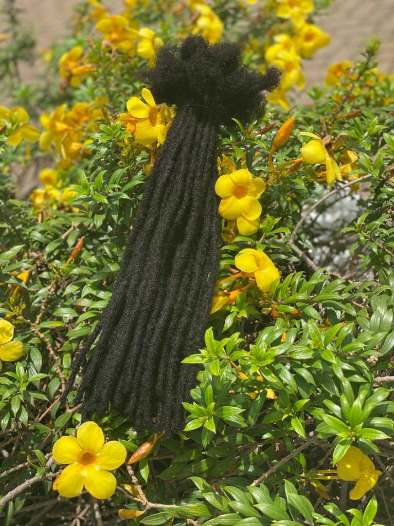 Artificial dreadlock extensions are pre-made dreadlock-like strands, typically made of synthetic hair, that are attached to natural hair to create the appearance of dreadlocks without the long-term co